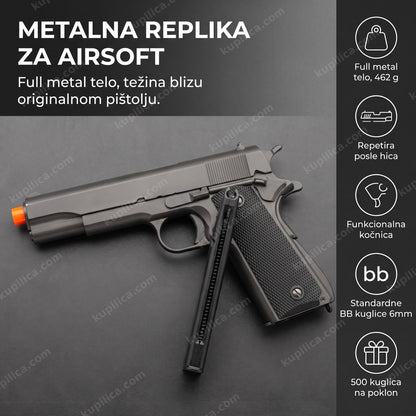 metalna airsoft replika pištolja kolt 1911 sa narandžastim vrhom cevi na stolu