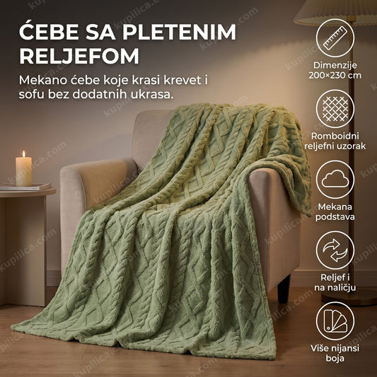 zeleno mekano ćebe sa reljefom prebačeno preko sofe u dnevnoj sobi