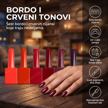 gel lak set bordo — šest bočica crvenih i bordo nijansi pored UV LED lampe na stolu za manikir