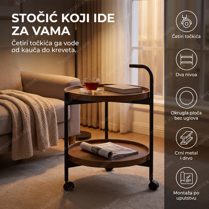okrugli crni stočić na točkićima sa dva nivoa pored kauča