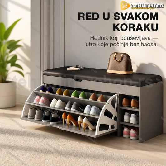 sivi cipelarnik sa tapaciranim sedištem u hodniku uz beli zid