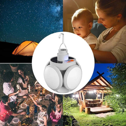 sklopiva solarna lampa za kampovanje okačena iznad stola sa hranom i pored šatora noću
