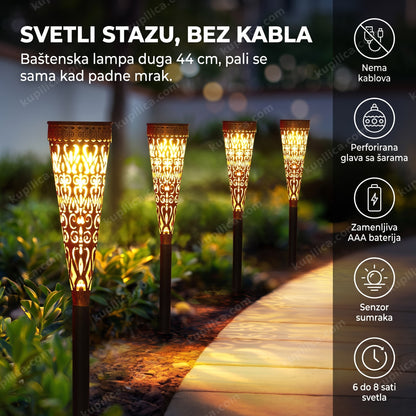 solarna baklja sa ornamentom osvetljava baštensku stazu uveče