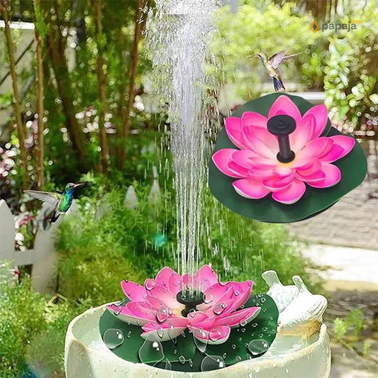 solarna fontana lotos u obliku ružičastog lokvanja sa mlazom vode u bašti, kolibri u letu