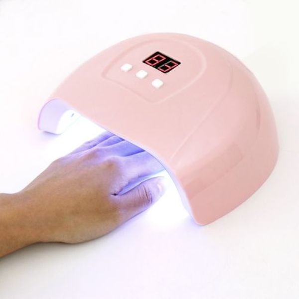 uv lampa za nokte — roze lampa od 54 W sa šakom unutra i upaljenim diodama